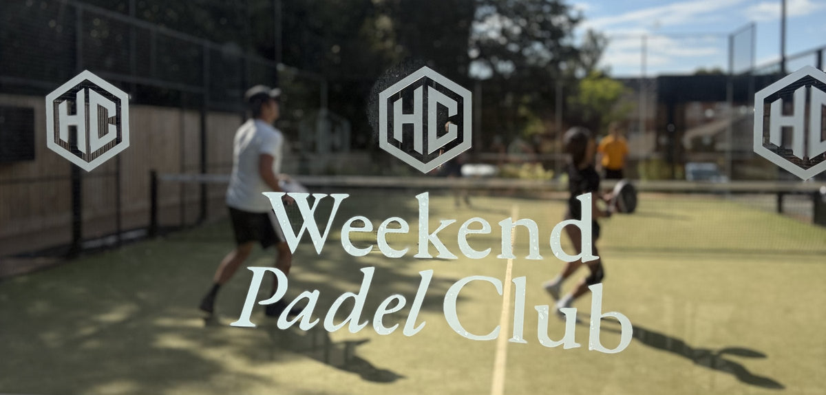 Weekend Padel Club logo on the glass at The Hook Club, with players on court behind
